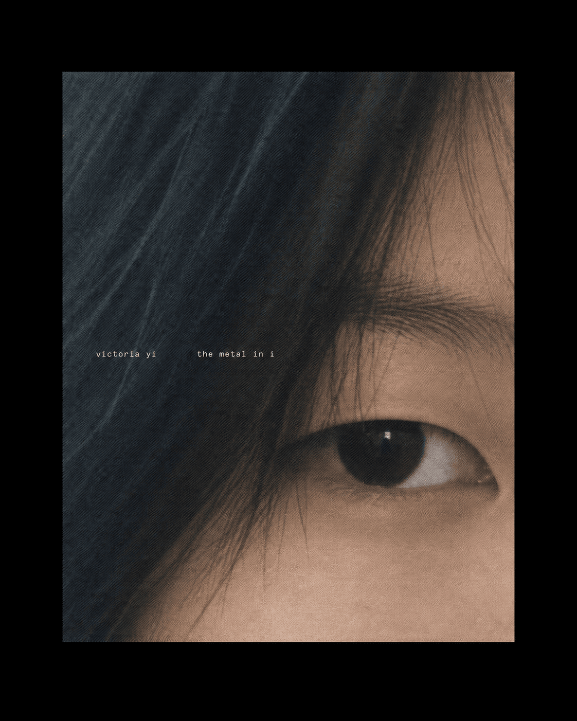 The metal in i cover featuring a close-up eye, dark hair, and small type on black